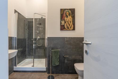 a bathroom with a shower and a toilet and a sink at Apartments La Cala by Wonderful Italy in Palermo