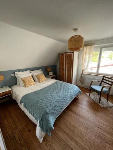 une chambre avec un grand lit dans une pièce dans l'établissement La Maison Blue, à Outreau