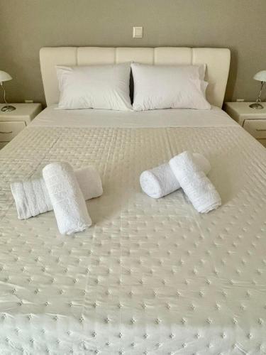 a white bed with two white pillows on it at Sky view in Taxiárkhai
