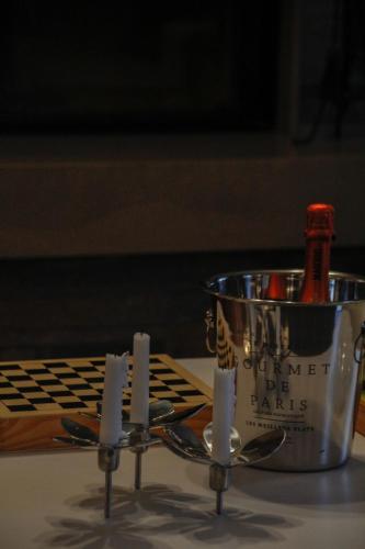 a candle holder with a bottle of wine in a bucket at VillaTonia - Suite home in Molfetta
