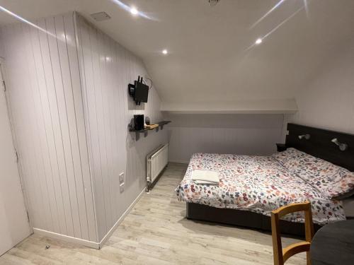 a small bedroom with a bed and a tv at OYO Queens Quarter in Belfast