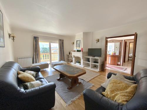 a living room with two couches and a coffee table at Holiday House Praia D Ana in Lagos