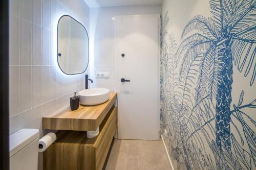 a bathroom with a sink and a mirror at La Calma in Platja  d'Aro