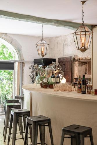 un bar avec quatre tabourets devant un comptoir dans l'établissement Domaine de La FELICITA, à Saint-Barthélemy