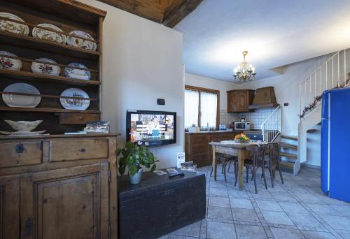 a kitchen with a table and a dining room at Au Petit Chevrot in Aosta
