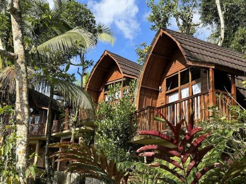 a log cabin in the woods with trees at Abing Dalem - Villa Nangka in Tabanan