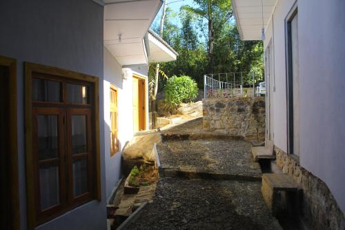 an alley between two buildings with a door at Triniton Holiday Villas in Hatton