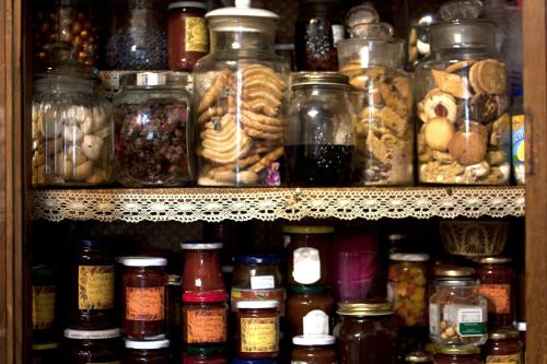 a shelf filled with lots of jars of food at Podere Badia Valdrago Agriturismo Mugello Circuit in Scarperia