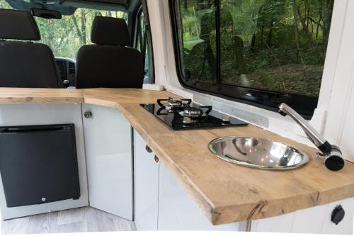 a kitchen with a sink in an rv at Viv The VW Campervan in Neath