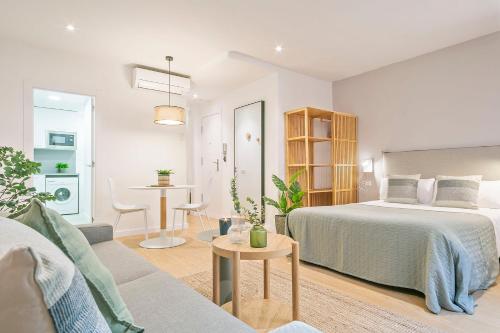 a bedroom with a bed and a living room at Citytrip Palau de la Música in Barcelona