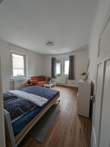 a bedroom with a bed and a living room at Ferienwohnung am Theater 2 in Schweinfurt