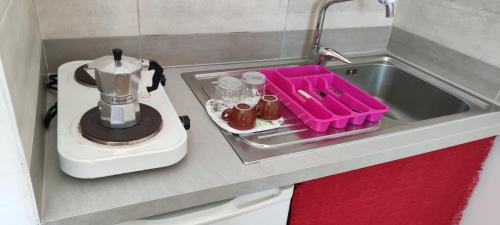 a kitchen sink with a tray and a blender at Cortili del Mar in Torre San Giovanni Ugento