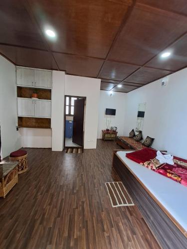 a bedroom with a large bed and wooden floors at Great Eastern Valley Residency in Gangtok