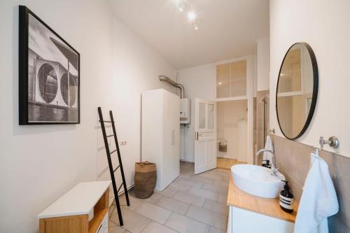 a bathroom with a sink and a mirror at NEW Urban Oasis - Sleek Apartment BY HOMLEY in Berlin