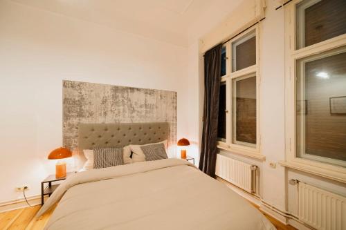 a bedroom with a large bed and a window at NEW Urban Oasis - Sleek Apartment BY HOMLEY in Berlin