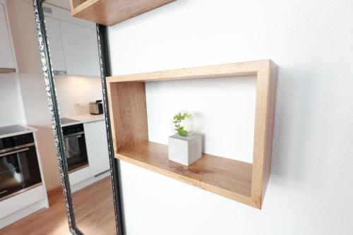 a mirror hanging on a wall in a kitchen at KoBi Apartments Falkenplatz in Luzern