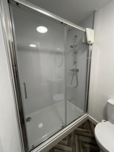 a glass shower in a bathroom with a toilet at No 8 Plants Yard Modern studio in Worksop in Worksop