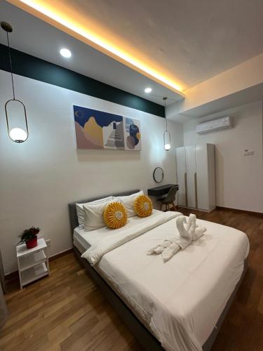 a bedroom with a large bed with two towels on it at Reizz Residence By D'Amour in Kuala Lumpur