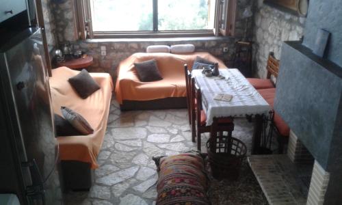 a living room with couches and a couch and a table at Ktima Charitou in Kalamaki Messinia