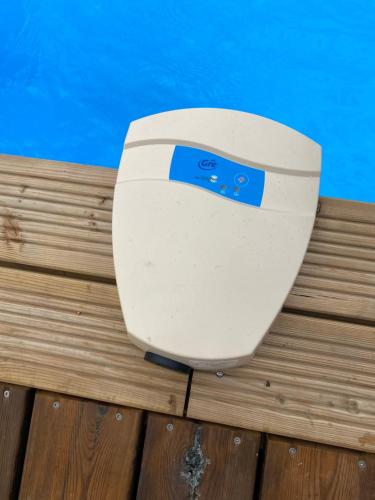 a toilet sitting on a deck next to a pool at Villa des Grenadelles in Saint-Paul