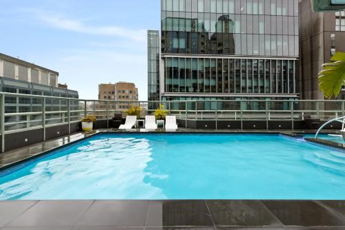 a large swimming pool on top of a building at Sydney Central Hotel managed by The Ascott Limited in Sydney