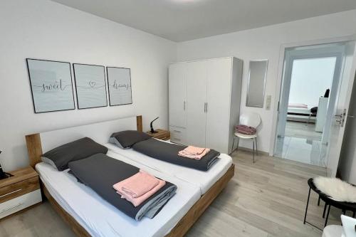 1 dormitorio con 2 camas y toallas rosas. en ganze Ferienwohnung 73m² in Wittlich, en Wittlich