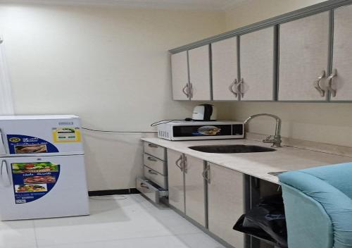 a kitchen with a sink and a refrigerator at فندق سما اشبيليه الرياض in Riyadh