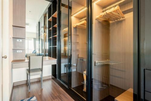 a walk in closet with a chair in a room at Luxury 31st Top Floor Condo with Swimming Pool in Chiang Mai