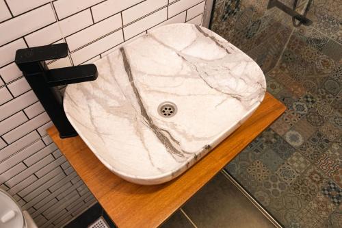 a bathroom with a white marble sink on a table at Ulo Lagos in Lekki