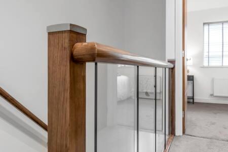 a wooden rail next to a staircase in a room at 2 bedroom house NE Norwich in Norwich