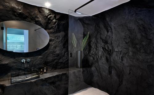 a bathroom with a sink and a mirror at Million Stars Mykonos in Mýkonos City