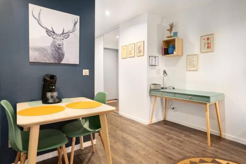 a dining room with a table and a desk at Studio cosy avec parking in Lyon