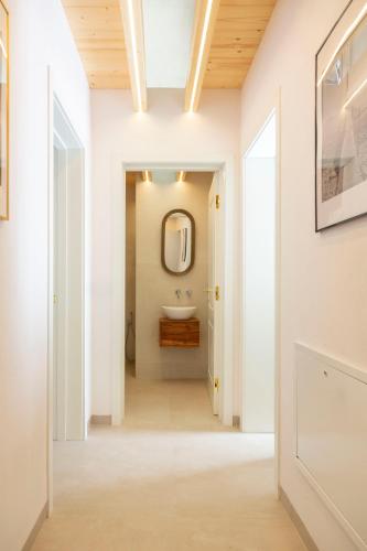 a hallway of a bathroom with a sink and a mirror at ALFA COUNTRY HOUSE Villa Salento in Lequile