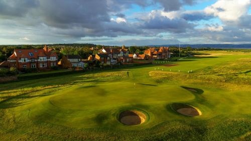 an overhead view of a golf course with a green at The Old Lifeboat Station of Hoylake in Hoylake