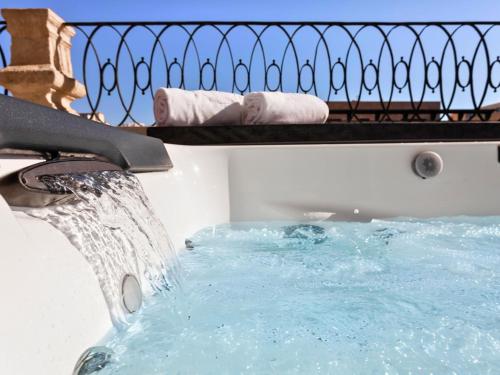 a bath tub with a water fountain at HO Puerta de Purchena By Olivencia in Almería