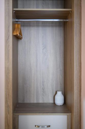 a wooden cabinet with a white vase on top of a drawer at Queen Charlotte Guesthouse in Edinburgh