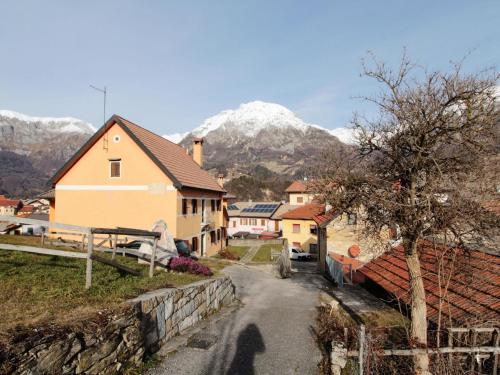 a village with a house and mountains in the background at Retreat in the Dolomites in Chies dʼAlpago