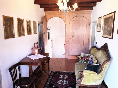 a room with a table and a chair and a desk at Retreat in the Dolomites in Chies dʼAlpago