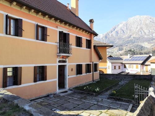 a building with a mountain in the background at Retreat in the Dolomites in Chies dʼAlpago