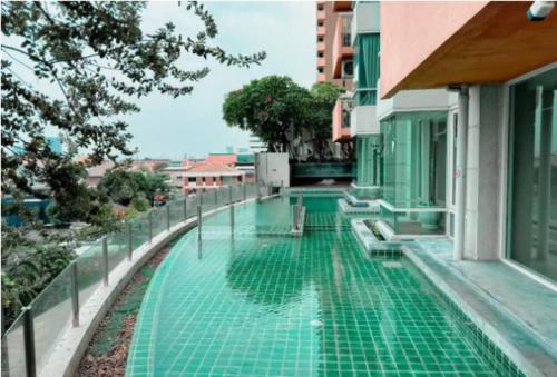 a swimming pool on the side of a building at 3 Beds: Wifi,Washer,LTAT,Impact in Pak Kret