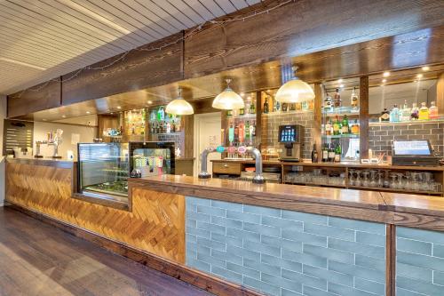 a bar in a restaurant with a wooden counter at The Derby Conference Centre and Hotel in Derby
