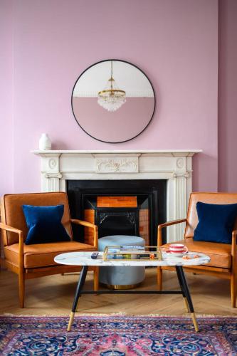 a living room with two chairs and a coffee table at Queen Charlotte Guesthouse in Edinburgh