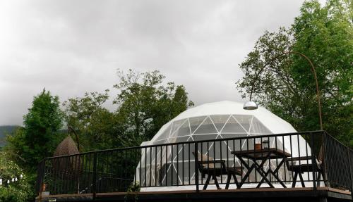 蓋貝萊的住宿－Dream Domes Glamping，阳台凉亭配有桌椅