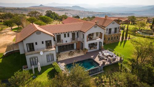 an aerial view of a house with a swimming pool at Mount High Luxury Country Estate in Lydenburg