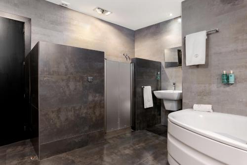 a bathroom with a toilet and a sink at Hotel Los Girasoles by Maxi Hoteles in Granada