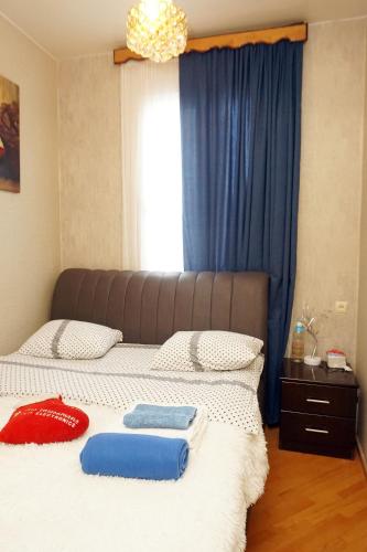 a bedroom with a bed with two pillows on it at Belas House With Terrace in Kutaisi