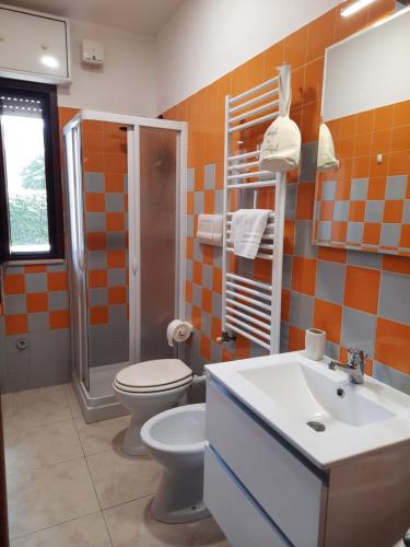 a bathroom with a toilet and a sink at B&B Costa Gentile in Taranto