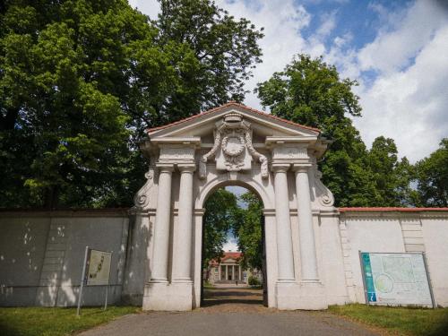 an archway with a building in the background at Palac Czerniejewo in Czerniejewo
