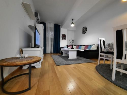 a living room with a table and a couch at IGX in Banja Luka