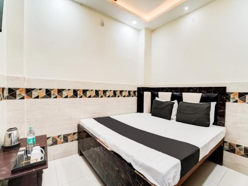 a bedroom with a bed and a table in it at OYO Flagship R. D. INN in Kānpur